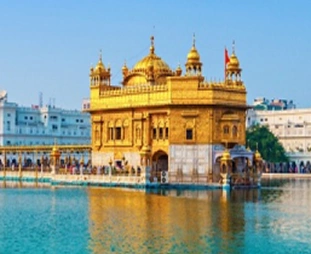 Golden Temple (Harmandir Sahib) shining in gold, surrounded by the Amrit Sarovar pool under a blue sky.